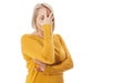 Curious woman covering face with hands peeping spying eye on white studio wall, funny woman feeling afraid fear shy Royalty Free Stock Photo