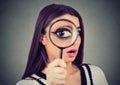 Curious woman looking through a magnifying glass Royalty Free Stock Photo