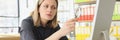 Curious woman looks at computer through magnifier glass