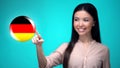 Curious woman pushing German flag button, ready to learn foreign language Royalty Free Stock Photo