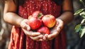 A curious young child gently grasping a ripe, red apple from a vibrant apple tree branch