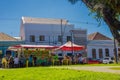 CURITIBA ,BRAZIL - MAY 12, 2016: some people eating outside next to a little food stand that offers some traditional