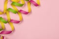 Curled party garlands on a pink background