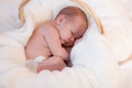 Curled up infant in basket Royalty Free Stock Photo