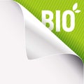 Curled white paper corner on green and Bio sign