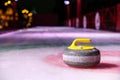 Curling stone on ice near the house Royalty Free Stock Photo