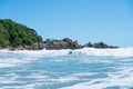 Curling wave in surf with surfer riding to shore