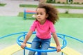 curly african american little child riding on carousel