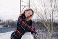 Curly blond pretty young woman in poncho in winter park. Cold weather. Holidays, season and leisure concept. Christmas Royalty Free Stock Photo