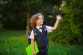 Curly blonde first-grader goes to school. Royalty Free Stock Photo