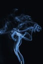 Curly blue cigarette smoke on a black background