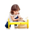 Curly child girl playing with kitten