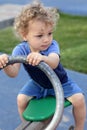 Curly child at seesaw