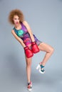 Curly confident glamourous female posing in red boxing gloves Royalty Free Stock Photo