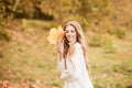 Curly cute girl in good mood posing in autumn day, enjoying good weather.