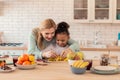 Curly daughter enjoying cooking with her foster mom Royalty Free Stock Photo