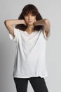 Curly fashion girl posing in white oversize t-shirt