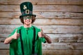 Curly funny man in St. Patrick`s hat .