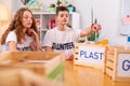 Curly girl joining her best friend while sorting waste together