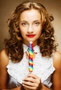 Curly girl with a lollipop in her hand Royalty Free Stock Photo