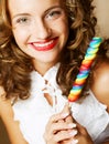 Curly girl with a lollipop in her hand Royalty Free Stock Photo