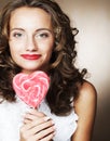 Curly girl with a lollipop in her hand Royalty Free Stock Photo