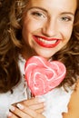 Curly girl with a lollipop in her hand Royalty Free Stock Photo