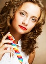 Curly girl with a lollipop in her hand Royalty Free Stock Photo