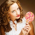 Curly girl with a lollipop in her hand Royalty Free Stock Photo