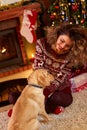 Curly girl with nice dog in Christmas evening Royalty Free Stock Photo