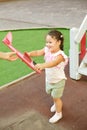 Curly girl playing on playground