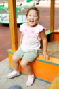 Curly girl playing on playground