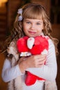 Curly girl with soft toy