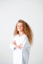 Curly girl in a white long sleeve t-shirt stands