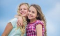 Curly and gorgeous hairstyles. Beautiful sisters. Hairdresser salon services. Two little girls kids with long curly hair