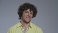 Curly guy hears the music and moves his head to the tact. Portrait of a dancing man. High quality