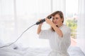 Curly Hair. Beautiful Smiling Woman With Long Blonde Wavy Hair Ironing It, Using Curling Iron. Happy Girl With Gorgeous Healthy Royalty Free Stock Photo