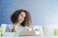 Curly hair teen girl reading book and eating salad Royalty Free Stock Photo