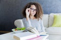 Curly hair teen girl reading book and eating salad Royalty Free Stock Photo