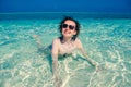 Curly hair woman in sunglasses have fun in turquoise crystal clear water. Idyllic paradise island. Exotic tropical beach. Summer v