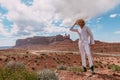 A curly haired blonde man posing around the famous Buttes of Monument Valley from Arizona, USA, wearing white linen shirt and Royalty Free Stock Photo