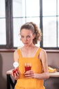 Curly-haired disquiet young lady having unusual food diet Royalty Free Stock Photo