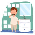 A curly-haired European boy with freckles in pajamas is brushing his teeth in the bathroom