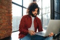 curly-haired man communicates by video communication, smiling and holding a laptop in his hands. Egyptian businessman Royalty Free Stock Photo