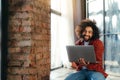 curly-haired man communicates by video communication, smiling and holding a laptop in his hands. Egyptian businessman Royalty Free Stock Photo