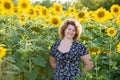 Curly-haired woman in field of sunflowers Royalty Free Stock Photo