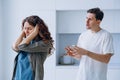 Woman plugs ears not wanting to hear husband quarrel shout