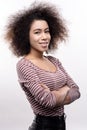 Curly-haired young folding her arms across chest