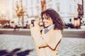 Curly laughing girl with vintage photo camera