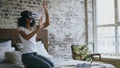 Curly mixed race teenager girl getting experience using VR 360 headset glasses of virtual reality at home Royalty Free Stock Photo